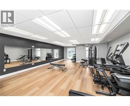 A gym with a variety of equipment including treadmills, weights, and exercise machines.