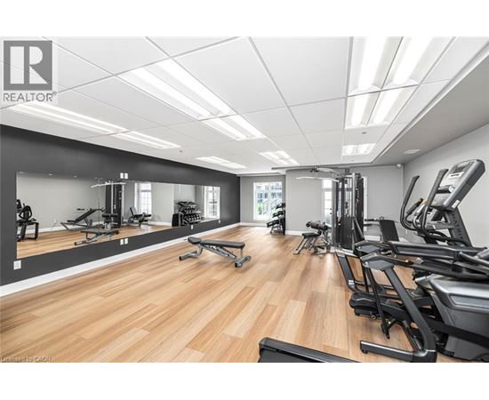 A gym with a variety of equipment including treadmills, weights, and exercise machines.