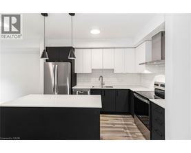 A modern kitchen with a black and white color scheme.