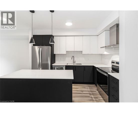 A modern kitchen with a black and white color scheme.