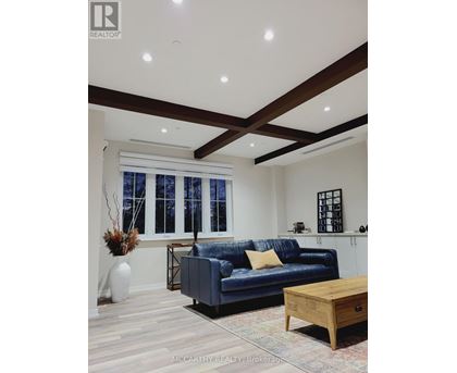 A living room with a blue couch and a wooden coffee table.