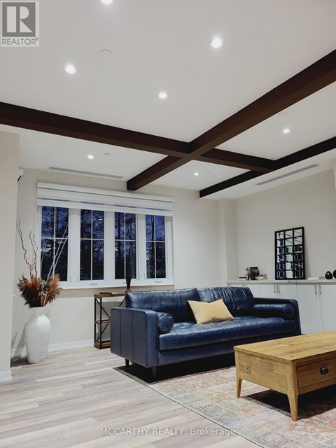 A living room with a blue couch and a wooden coffee table.