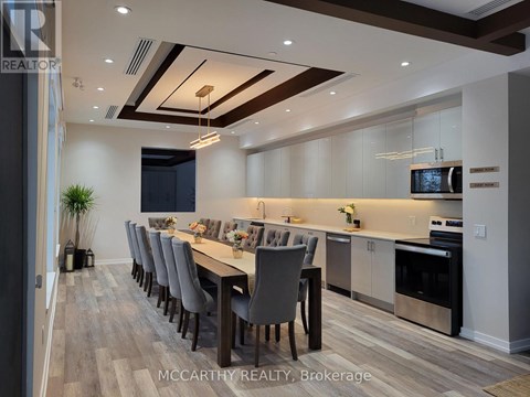 A modern dining room with a long table and chairs.