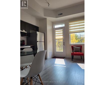 A bright kitchen with a glass table and chairs.