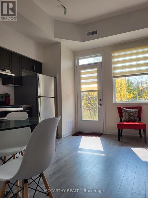 A bright kitchen with a glass table and chairs.