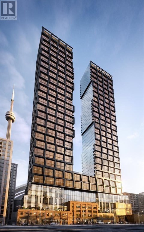 Two tall buildings with a glass facade stand next to a shorter building with a brown facade.