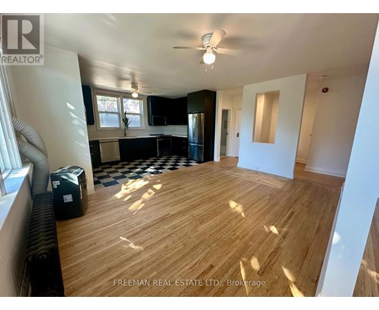 A room with wooden flooring and a ceiling fan.