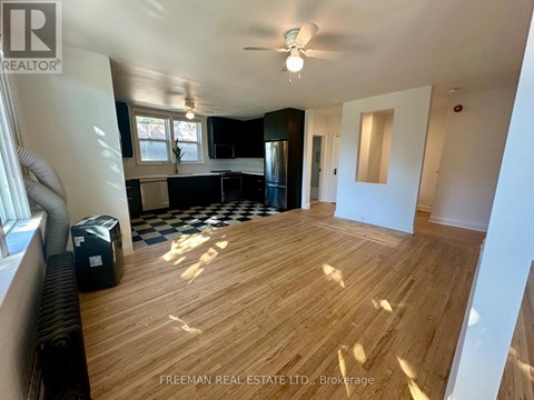 A room with wooden flooring and a ceiling fan.