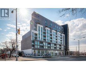 A modern multi-story building with a glass facade is the main focus of the image.