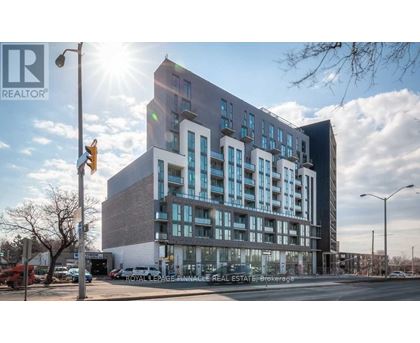 A modern multi-story building with a glass facade is the main focus of the image.