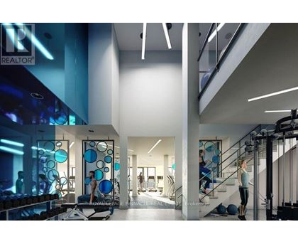 A gym with a woman exercising on a treadmill.