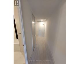 A hallway with a door at the end.
