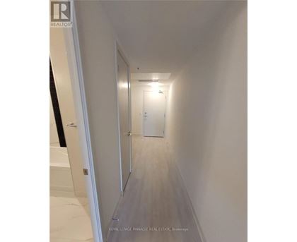 A hallway with a door at the end.