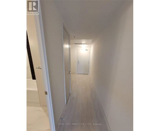 A hallway with a door at the end.