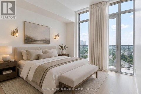 A bedroom with a large bed and a view of the city.