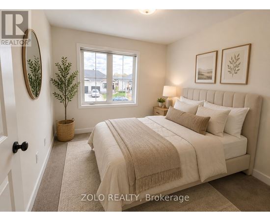 A bedroom with a large bed and a window overlooking a street.