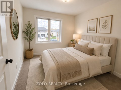 A bedroom with a large bed and a window overlooking a street.