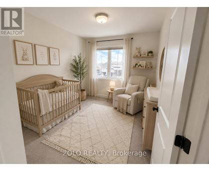 A well-lit nursery room with a crib, a chair, and a small tree.