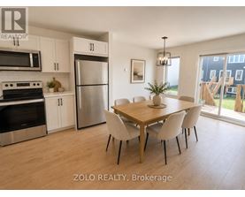 A kitchen with a dining table and chairs.