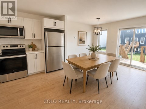 A kitchen with a dining table and chairs.