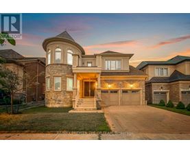 A large house with a stone facade and a large front yard.