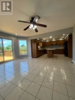 A spacious room with a ceiling fan and tiled flooring.