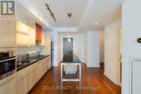 A modern kitchen with wooden cabinets and a central island.