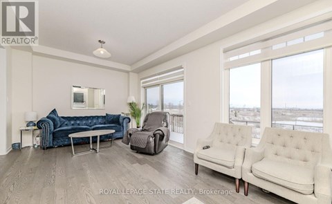 A living room with a blue couch and a white couch.