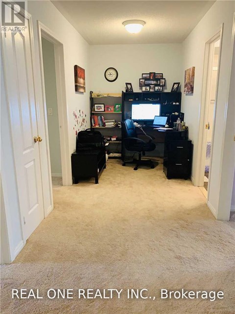 A room with a desk, chair, and a bookshelf.