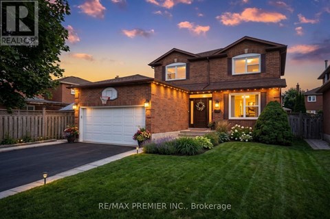 A house with a garage and a driveway is shown.
