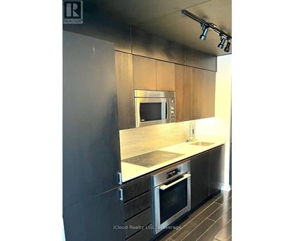 A modern kitchen with a stainless steel oven and microwave.