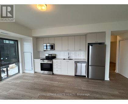 A kitchen with white cabinets and stainless steel appliances.