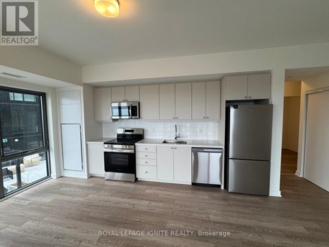 A kitchen with white cabinets and stainless steel appliances.