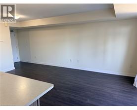 A room with a white table and dark wood flooring.