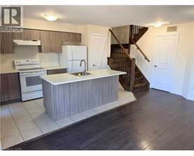 A kitchen with a white island in the middle of the room.