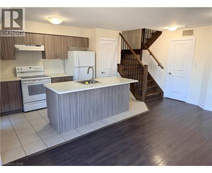 A kitchen with a white island in the middle of the room.