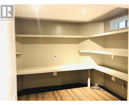 A room with a lot of empty space and a window.