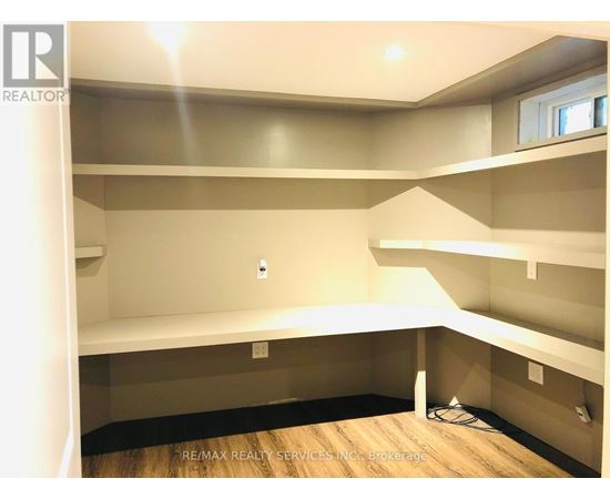 A room with a lot of empty space and a window.