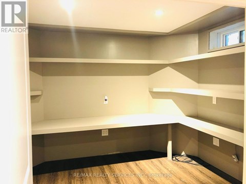 A room with a lot of empty space and a window.