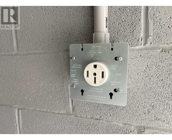A wall socket with a key slot and a key inserted.