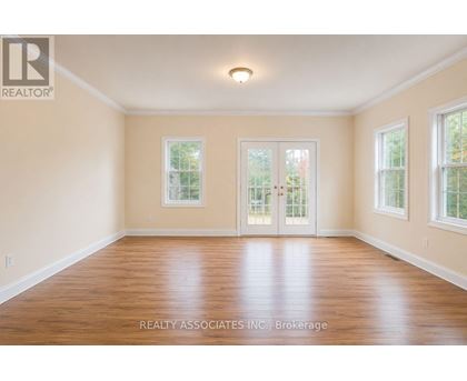 A room with wooden floors and white walls.