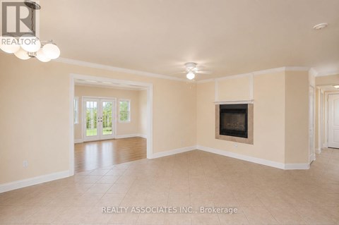 A spacious living room with a fireplace and sliding glass doors.