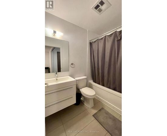 A bathroom with a toilet, sink, and bathtub.