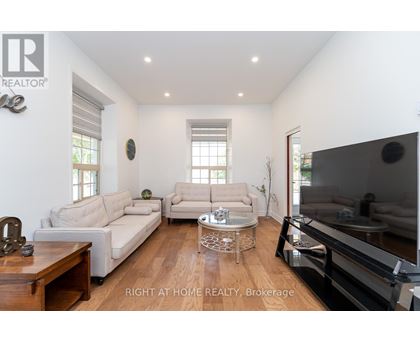 A living room with a white couch and a wooden coffee table.