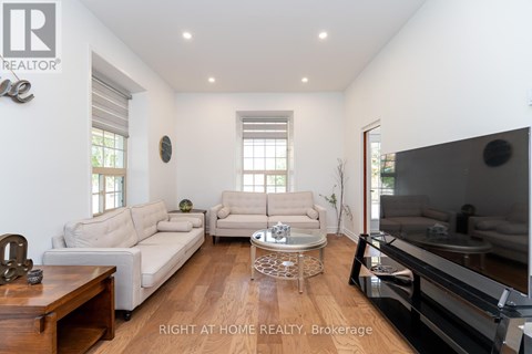 A living room with a white couch and a wooden coffee table.