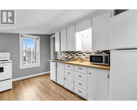 A kitchen with white cabinets and a wooden countertop.