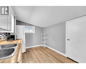 A kitchen with a sink and a window.