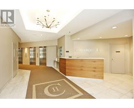 A reception area with a wooden desk and a chandelier.