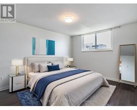 A bedroom with a large bed and a mirror on the wall.