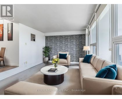 A modern living room with a stone wall and a large window.
